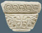 The one facade of a marble capital with cross and ivy leaves in the gaps. Dimensions: height: 30 cm, base diameter: 21 cm, abacus: 45x58.
 
